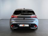 the rear end of a silver car in a white room
