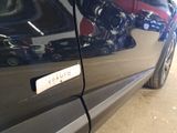 a close up of a car door handle with a sticker on it