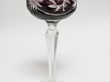 purple wine glass with white flowers on a stem on a white background