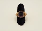 an image of a gold ring with an amethorate stone