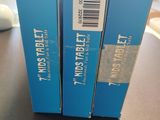 two blue boxes with a barcode on them sitting on a table