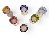 six different colored glass knobs on a white surface