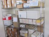 a metal shelving with many boxes and boxes on it