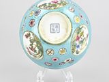 a blue bowl with flowers on it on a clear stand