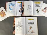 six books of children ' s drawings and drawings are spread out on a table
