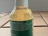 a bottle of liquid sitting on a counter top