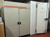 a large white refrigerator sitting in a room next to a pile of boxes