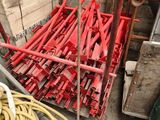 a pile of red hoses sitting on the ground next to a pile of other hoses