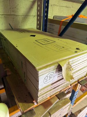 a large stack of books sitting on a pallet in a warehouse