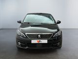 the front of a black car is parked in a white room