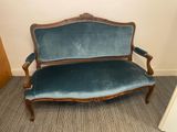 a blue couch that is sitting in the corner of a room