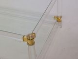 rectangular clear glass coffee table with gold accents