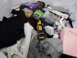 a trash can filled with various items that include a laptop, a cell phone, and other items