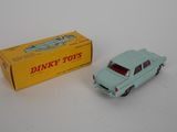 an old toy car is sitting next to a box of dinky toys