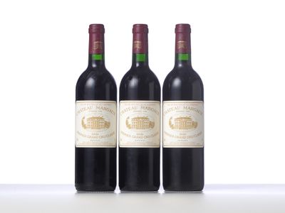 three bottles of wine are lined up on a table