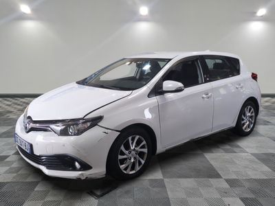 the white toyota corolla is parked on a checkered tile floor