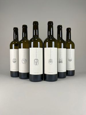 six bottles of wine are lined up on a table