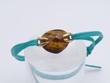 a close up of a glass of water with a bracelet on it