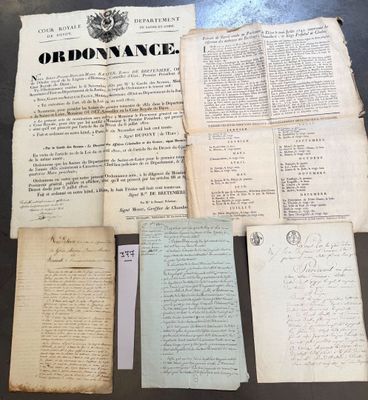 several old papers are sitting on top of a table