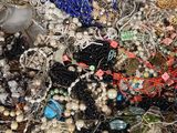 a pile of assorted beads and jewelry on a table