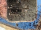 a close up of a person ' s hand holding a piece of metal