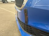 a close up of a car ' s grille with a number plate on it