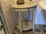 une petite table sur laquelle est posée une bougie, dans une salle de bains