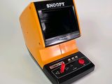 an orange and black electronic device on a white surface