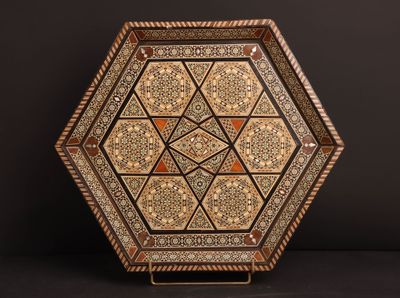 a decorative wooden tray with a geometric design on it