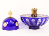 a blue glass bowl with a gold lid and a blue glass bowl with a gold lid