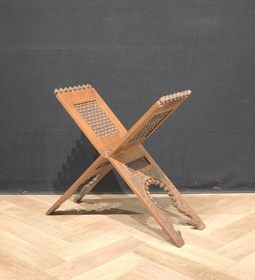 une image représentant une chaise en bois posée sur un parquet en bois massif