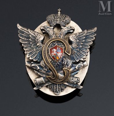 an image of a silver and gold broochle with a crown on it