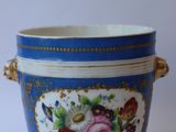 an image of a blue and white vase with flowers on it