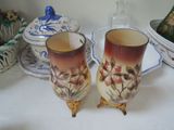 two vases that are sitting on a table
