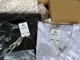 boxes of men ' s and women ' s t - shirts on display in a store