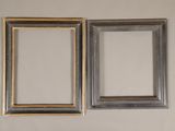 two picture frames hanging on the wall next to each other