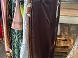 a lot of clothes hanging on a rack in a store