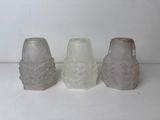 three salt and pepper shakers sitting next to each other