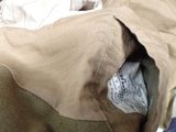 a bag with a newspaper inside of it sitting on a couch