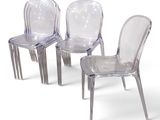 three clear plastic chairs sitting next to each other on a white surface