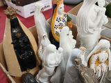 a box full of ceramic figurines sitting on a table