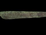 an image of a knife that is on a black surface