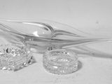 a glass spoon and a glass bowl on a table