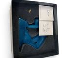 a box with a pair of blue shoes inside of it