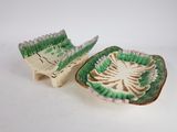 pair of green and white pottery dishes with a palm leaf design