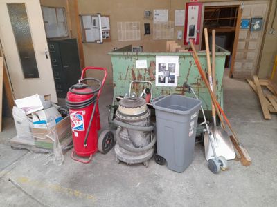 many different types of trash cans in this garage