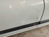 a close up of a white car with a black stripe on the side