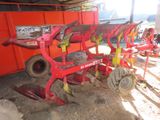 a red machine that is sitting in the dirt