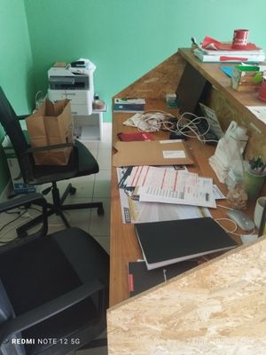an image of a desk with a lot of clutter on it