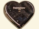 a silver heart shaped brooch with a name on it